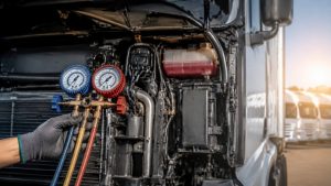 Commercial truck fleet AC maintenance inspection with refrigerant pressure gauge testing